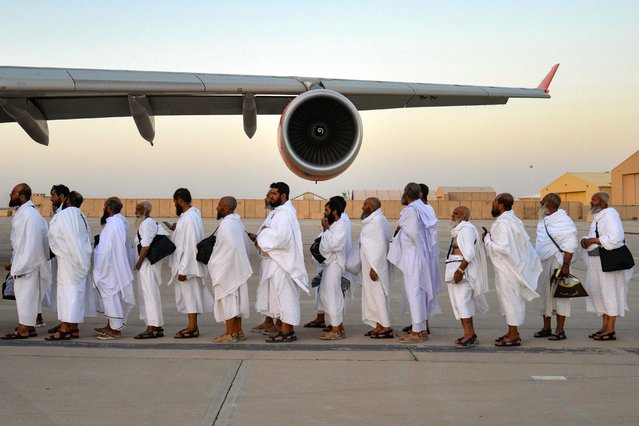 Afghan Hajj pilgrims board a plane to Saudi Arabia at Kandahar airport on May 12, 2025. (Photo by Sanaullah Seiam/AFP Photo)