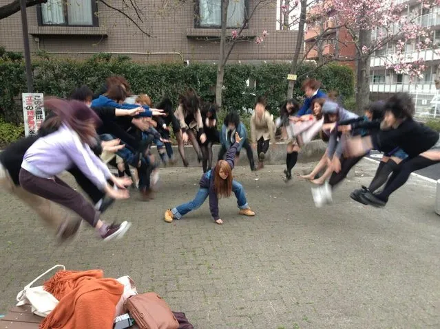 There is a massive internet photo trend brewing amongst youths in Japan right now that involves taking pictures of teens who appear to be releasing invisible energy that sends their peers flying. The photo mania is especially popular amongst schoolgirls who started the trend by uploading images on Twitter and labeling them as “Makankosappo”, a reference to a special attack in the popular manga-turned-anime Dragon Ball series. In anticipation of a new Dragon Ball Z movie, these pictures of teens playfully performing air-bending feats have been turning up from all over Japan. (Photo by Danny Choo)