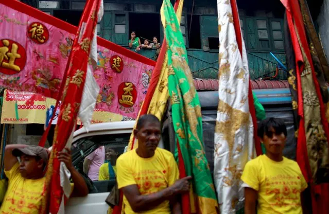 Myanmar Chinese people watch from their home, during a festival dedicated to Buddhist monk Shin Upagutta, celebrated by Myanmar's ethnic Chinese community, in Chinatown in Yangon October 21, 2015. (Photo by Soe Zeya Tun/Reuters)