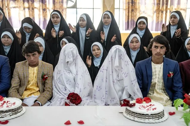 Afghan brides and grooms participate in a mass wedding ceremony during the International Women's Day, in Kabul, Afghanistan, Wednesday, March 8, 2023. (Photo by Ebrahim Noroozi/AP Photo)