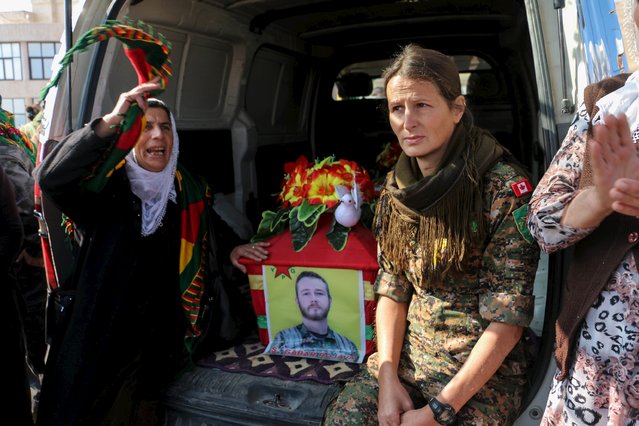 Kurdish People's Protection Units (YPG) fighters and supporters mourn around the coffin of fellow fighter John Robert Gallagher, a Canadian who died on November 4 in battle with Islamic State fighters, during his funeral in Hasaka, Syria November 12, 2015. (Photo by Rodi Said/Reuters)