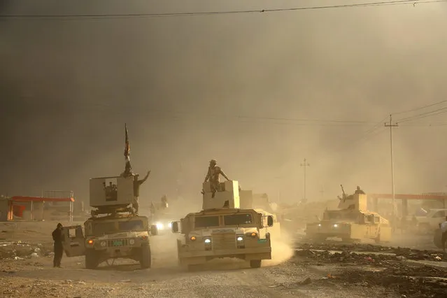 An Iraqi military convoy advances towards the city of Mosul, Iraq, Wednesday, October 19, 2016. A senior Iraqi general on Wednesday called on Iraqis fighting for the Islamic State group in Mosul to surrender as a wide-scale operation to retake the militant-held city entered its third day. (Photo by AP Photo)