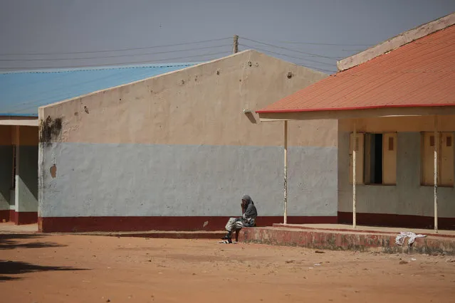 A parent sit outside the Government Science school after gunmen abducted students from it, in Kankara, in northwestern Katsina state, Nigeria December 15, 2020. Boko Haram on Tuesday claimed the abduction of hundreds of students, marking its first attack in northwestern Nigeria since the jihadist uprising began more than ten years ago. (Photo by Kola Sulaimon/AFP Photo)