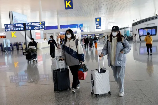 Travellers walk with their luggage at Wuhan Tianhe International Airport following the coronavirus disease (COVID-19) outbreak in Wuhan, Hubei province, China on January 2, 2021. (Photo by Tingshu Wang/Reuters)