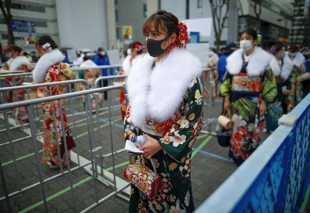 Kimono-clad women wearing protective face masks wait to receive their body temperature check as they attend their Coming of Age Day celebration ceremony at Yokohama Arena during the government declared the second state of emergency for the capital and some prefectures, amid the coronavirus disease (COVID-19) outbreak, in Yokohama, south of Tokyo, Japan on January 11, 2021. Of Tokyo's 23 wards, all but one have canceled or postponed the ceremonies, opting instead to offer mayors' congratulatory remarks online. The government last week declared a state of emergency for the capital and three surrounding prefectures. (Photo by Issei Kato/Reuters)