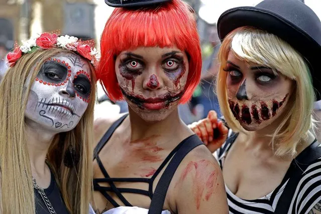 Women in zombie costumes take part in the Zombie Walk in Sao Paulo, Brazil, Wednesday, November 2, 2016. Participants commemorated the Day of the Dead with the annual Zombie Walk. (Photo by Andre Penner/AP Photo)