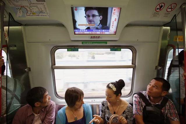 Passengers watch a television screen broadcasting news on Edward Snowden, a contractor at the National Security Agency (NSA), on a train in Hong Kong June 14, 2013. FBI Director Robert Mueller said on Thursday that the U.S. government is doing everything it can to hold confessed leaker Edward Snowden accountable for splashing surveillance secrets across the pages of newspapers worldwide. (Photo by Bobby Yip/Reuters)