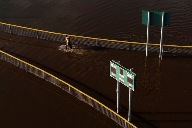 A drone view shows a person walking between baseball fields flooded by the Snoqualmie River, as an atmospheric river brings rain and flooding to the Pacific Northwest, in Fall City, Washington, on December 9, 2025. (Photo by David Ryder/Reuters)