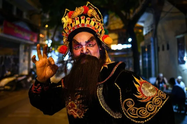 This picture taken on September 25, 2020 shows an artist from the traditional Vietnam Tuong Theatre posing for a photograph on a street in the old quarters of Hanoi, ahead of the Mid-Autumn Festival celebrations. (Photo by Manan Vatsyayana/AFP Photo)