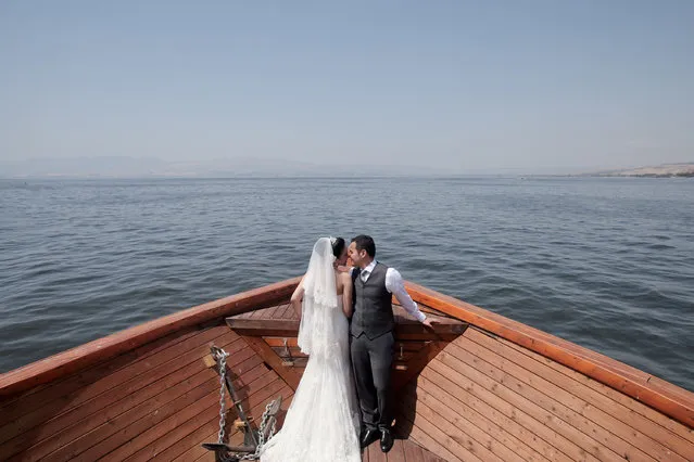 “I Do”. In the middle of the Sea of Galilee, there was a happy newly wedding couple having their love celebration on the boat. Location: Sea Of Galilee, Israel. (Photo and caption by Lydia Isnanto/National Geographic Traveler Photo Contest)