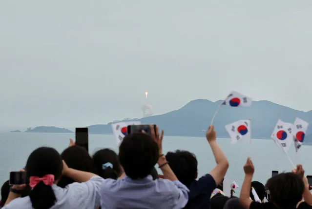 People watch the launch of South Korea’s homegrown Nuri space rocket in Goheung, South Korea on May 25, 2023. (Photo by Yonhap via Reuters)