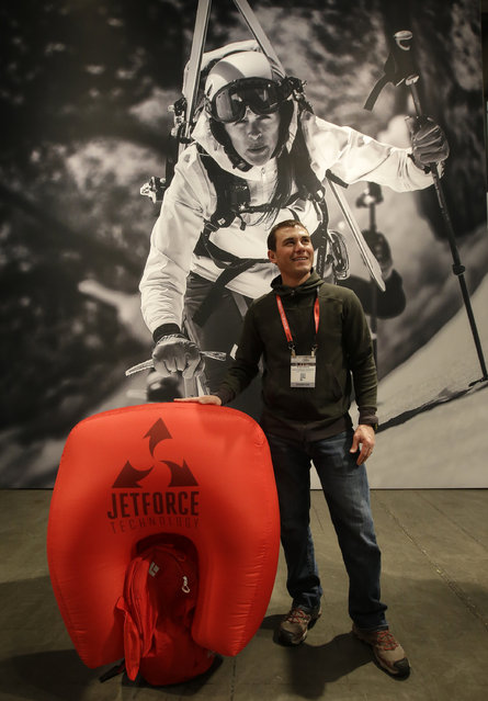 Ryan Guess, with Black Diamond, holds their JetForce Avalanche Airbag Pack at their exhibit at the Outdoor Retailer Show Thursday, January 22, 2015, in Salt Lake City. (Photo by Rick Bowmer/AP Photo)