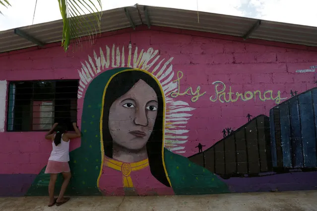 A girl talks to a person (not pictured) at the premises of a group called “Las Patronas” (The bosses), a charitable organization that feeds Central American immigrants on their way to the border with the United States who travel atop a freight train known as “La Bestia”, in Amatlan de los Reyes, in Veracruz state, Mexico October 22, 2016. (Photo by Daniel Becerril/Reuters)