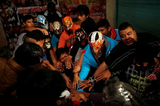 Wrestlers join hands before an extreme wrestling fight in a ring inside a car wash in Tulancingo Hidalgo, Mexico October 8, 2016. (Photo by Carlos Jasso/Reuters)