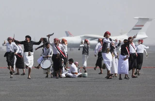 People perform the Baraa dance at Sanaa Airport, amid a prisoner swap between two sides in the Yemen conflict, in Sanaa, Yemen on April 16, 2023. (Photo by Khaled Abdullah/Reuters)