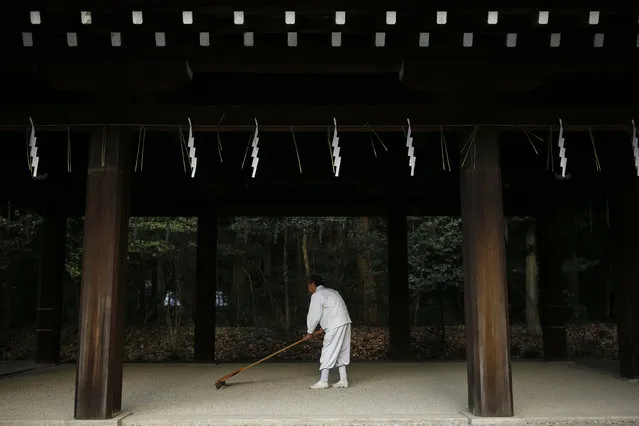 A man cleans the floor of a prayer hall after a Shinto New Year ritual at the Meiji Shrine in Tokyo, Japan, December 31, 2015. (Photo by Thomas Peter/Reuters)