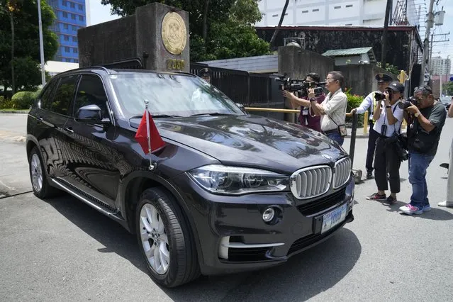 Journalists take pictures of a car with diplomatic plates and Chinese flag leaves the Philippine Department of Foreign Affairs in Manila, Philippines on Monday, August 7, 2023. The Philippine government summoned the Chinese ambassador on Monday to convey a diplomatic protest over the Chinese coast guardÅfs use of a water cannon against a Filipino supply boat in the disputed South China Sea, a Philippine official said. (Photo by Aaron Favila/AP Photo)