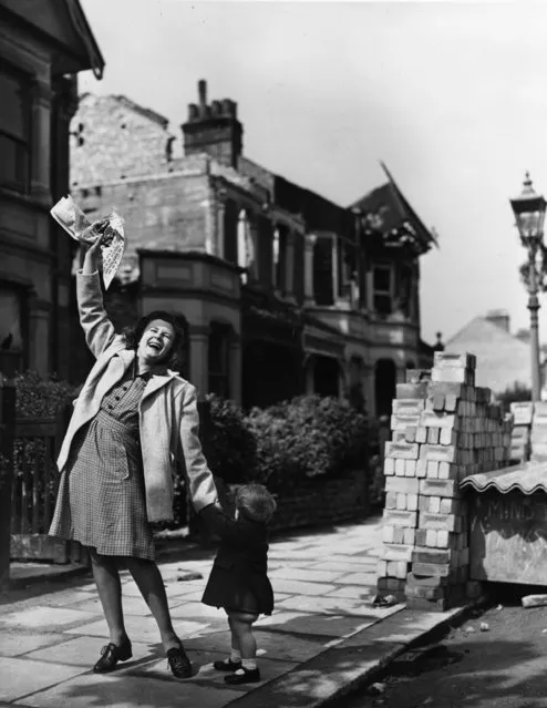 Mrs Pat Burgess of Palmer's Green, north London is thrilled to get the news that her husband will soon be home for good from Germany, 7th May 1945. (Photo by Reg Speller/Fox Photos/Getty Images)