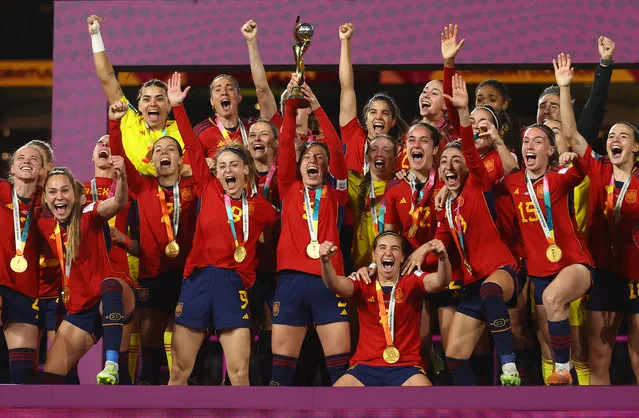 Spain's players celebrate with the trophy after winning the Australia and New Zealand 2023 Women's World Cup final football match between Spain and England at Stadium Australia in Sydney on August 20, 2023. (Photo by Carl Recine/Reuters)