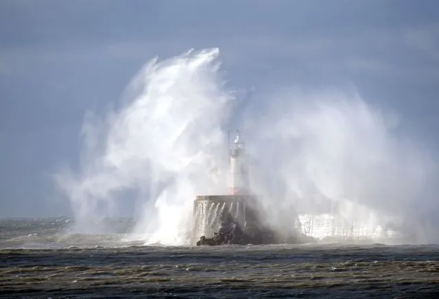 High winds, heavy and stormy seas batter the Newhaven lighthouse and harbour in East Sussex, United Kingdom on May 4, 2021. (Photo by Martin Dalton/Rex Features/Shutterstock)