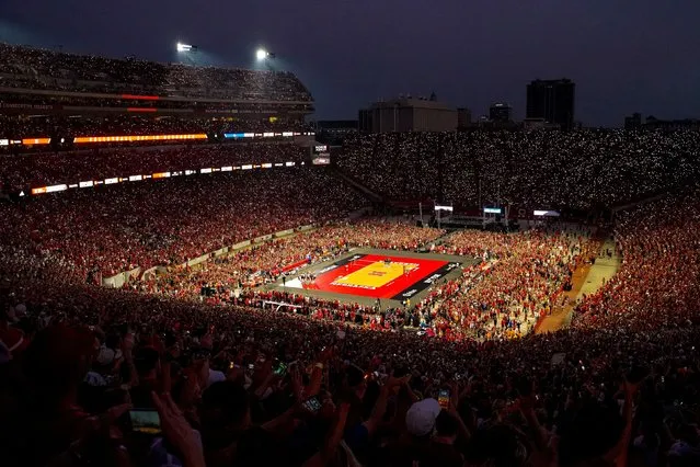 Fans hold up cell phone lights before the third set between the Nebraska Cornhuskers and the Omaha Mavericks at Memorial Stadium in Lincoln, NE on August 30, 2023. The event set a world attendance record for a women's sporting event with 92,003 fans. (Photo by Dylan Widger/USA TODAY Sports)