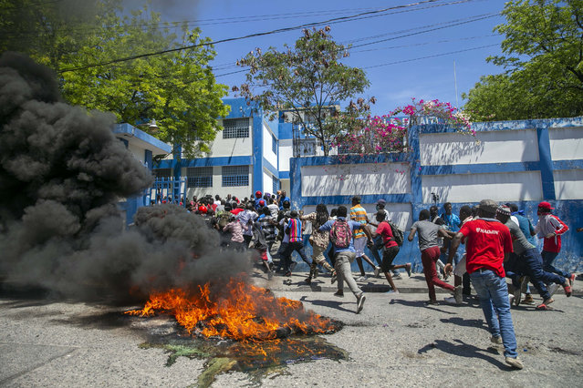 Protestors and a disgruntled sector of the Haitian police force known as Fantom 509 storm a police station to free imprisoned fellow officers in Delmas, Port-au-Prince, Haiti, Wednesday, March 17, 2021. (Photo by Dieu Nalio Chery/AP Photo)