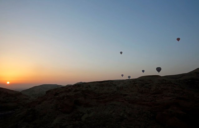 Hot-air balloons carrying tourists fly at sunrise over the city of Luxor, south of Cairo, Egypt December 13, 2016. (Photo by Amr Abdallah Dalsh/Reuters)