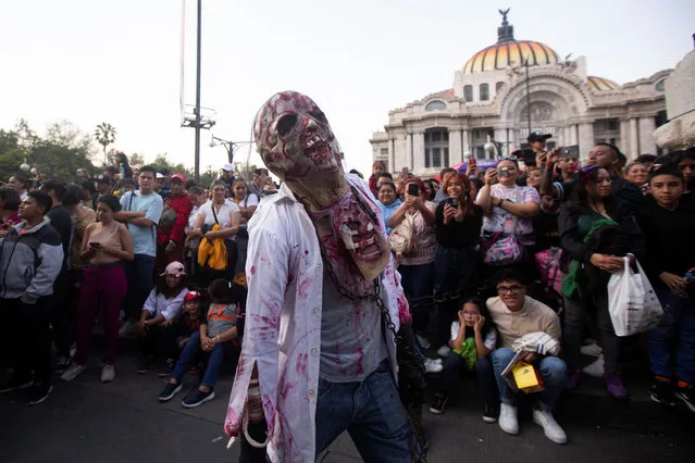 A person dressed as a zombie takes part in the annual Zombie Walk in Mexico City, Mexico on October 21, 2023. (Photo by Quetzalli Nicte-Ha/Reuters)
