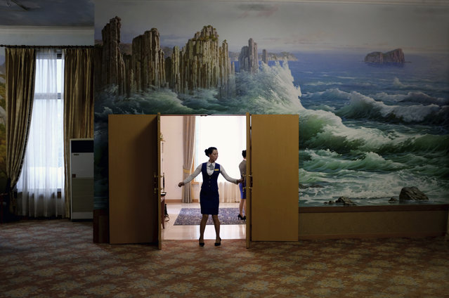 In this Tuesday, October 23, 2018, photo, a staff member closes the doors of a meeting room at the Kumgangsan Hotel at the Mount Kumgang resort area which was once a popular destination for South Korean tourists, in North Korea. A decade after the North-South experiment in tourism cooperation in Kumgang ended in bitter failure following the fatal shooting of a South Korean tourist in 2008, North Korean leader Kim Jong Un and South Korean President Moon Jae-in want to give it another try amid opposition from Washington. (Photo by Dita Alangkara/AP Photo)