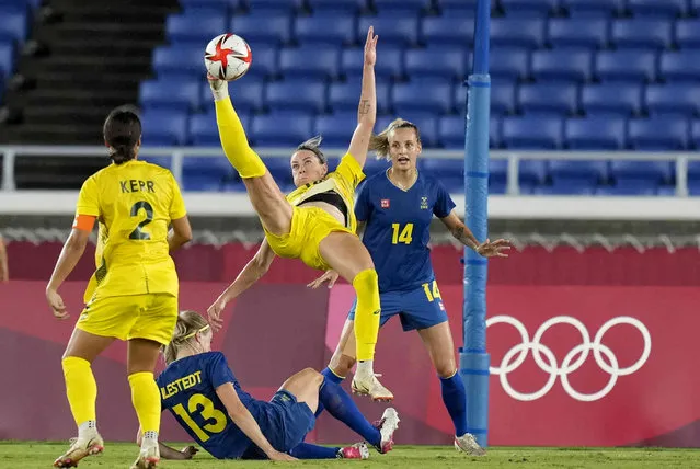 Australia's Alanna Kennedy jumps for the ball during a women's semifinal soccer match against Sweden at the 2020 Summer Olympics, Monday, August 2, 2021, in Yokohama, Japan. (Photo by Silvia Izquierdo/AP Photo)