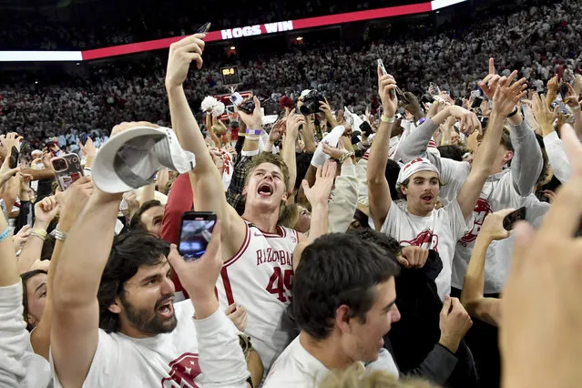 Arkansas' Lawson Blake (45) celebrates with fans after defeating Duke in an NCAA college basketball game Wednesday, November 29, 2023, in Fayetteville, Ark. (Photo by Michael Woods/AP Photo)