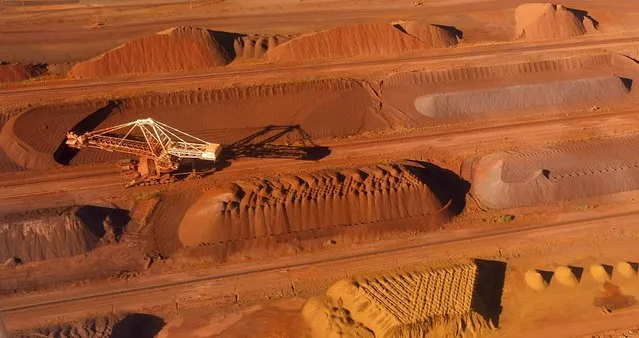 A bucket wheel reclaimer collects ore at the BHP Billiton iron ore loading facility in Port Hedland, north of Perth, Australia in this May 26, 2008 file photo. Top global miner BHP Billiton slashed its interim dividend by 75 percent on February 23, 2016, abandoning a long-held policy of steady or higher payouts as it braces for a longer-than-expected commodities downturn. (Photo by Tim Wimborne/Reuters)