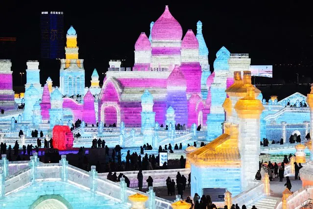 This photo taken on December 17, 2023 shows people visiting the 25th Harbin Ice and Snow World in Harbin, in China's northern Heilongjiang province. (Photo by AFP Photo/China Stringer Network)