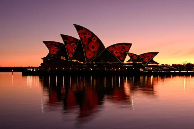 The sails of the Sydney Opera House are illuminated with poppies at dawn to mark Remembrance Day, in Sydney, Australia on November 11, 2022. (Photo by Jaimi Joy/Reuters)