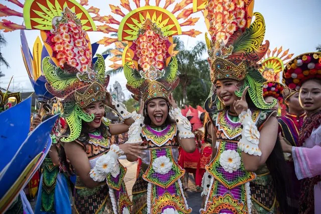 Balinese dancers perform as they take part in a cultural parade, during a new year's eve celebration at a main road in Denpasar, Bali, Indonesia, 31 December 2023. (Photo by Made Nagi/EPA)