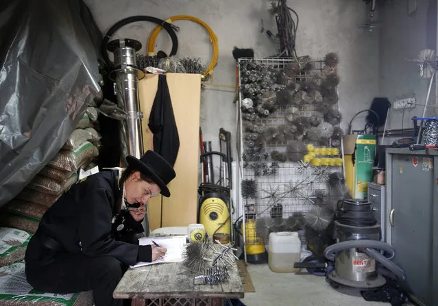 Dajana Djuric, 25, who has worked as a chimney sweep since the age of six, prepares in her office before cleaning chimneys in Brcko, Bosnia and Herzegovina. Picture taken March 3, 2016. (Photo by Dado Ruvic/Reuters)
