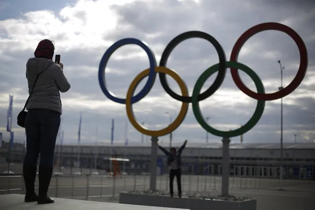 Railway passengers take photos in front of the Olympic Rings at the Olympic Park train station ahead of the upcoming 2014 Winter Olympics, Wednesday, February 5, 2014, in Sochi, Russia. (Photo by David Goldman/AP Photo)