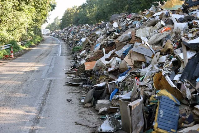 This photograph taken on September 3, 2021 shows trash on the abandoned A601 highway at Juprelle, near Liege. The makeshift dump – comprising 90,000 tonnes of domestic debris stretching a total eight kilometres (five miles) in both directions of the closed A601 motorway north of the city of Liege – is testament to the devastation wreaked by unprecedented floods in mid-June. (Photo by Francois Walschaerts/AFP Photo)