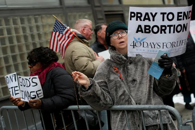 A woman prays during an anti-Planned Parenthood vigil outside the Planned Parenthood – Margaret Sanger Health Center in Manhattan, New York, U.S., February 11, 2017. (Photo by Andrew Kelly/Reuters)