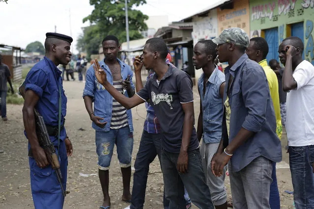 Residents argue with a police officer in the Mutakara district of Bujumbura, Burundi, Monday, May 4, 2015. (Photo by Jerome Delay/AP Photo)