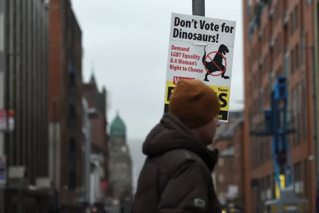 A man walks past an electionl poster saying “Don't vote for Dinosaurs!” in Belfast, Northern Ireland February 6, 2017. (Photo by Clodagh Kilcoyne/Reuters)