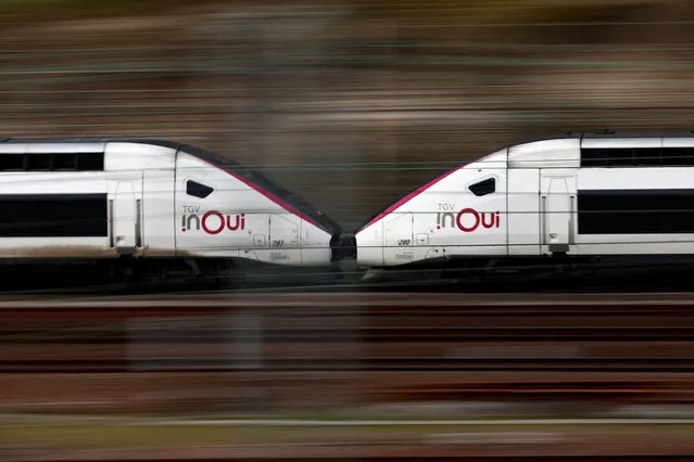 A TGV high speed train drives past a SNCF depot station in Charenton-le-Pont near Paris ahead of a national strike by French SNCF (French state-owned railway company) controllers in France, on February 15, 2024. (Photo by Gonzalo Fuentes/Reuters)