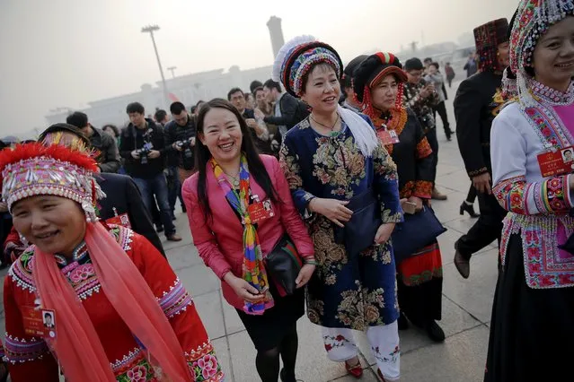Ethnic minority delegates laugh as they arrive for the closing ceremony of China's National People's Congress (NPC) at the Great Hall of the People in Beijing, China, March 16, 2016. (Photo by Damir Sagolj/Reuters)