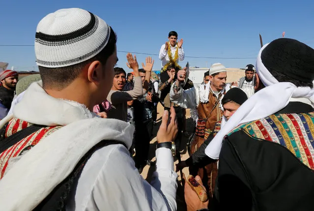 The Syrian refugee folklore troupe Abu Rustom perform at a wedding show at Zaatari refugee camp in the Jordanian city of Mafraq, near the border with Syria February 20, 2017. The Syrian troupe is trying to keep its country's traditions alive by holding traditional dances and performing celebratory sword fights during weddings and other occasions, according to the troupe's leader. (Photo by Muhammad Hamed/Reuters)