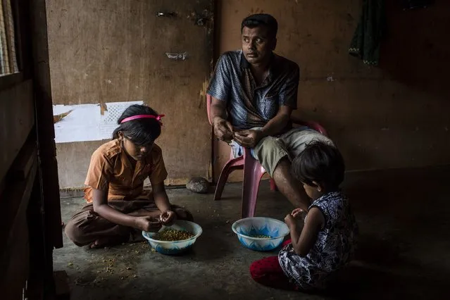 A Rohingya refugee Muhammad Rofiq (37), with his daughters prepare for food inside their refugee camp on February 11, 2017 in Medan, North Sumatra, Indonesia. Muhammad Rofiq, have been in refugee camp for six years and are not able to legally work while waiting for registration and resettlement. (Photo by Ulet Ifansasti/Getty Images)