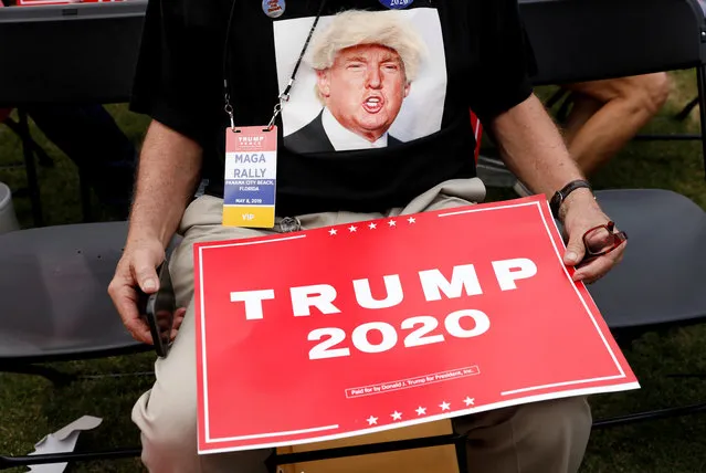 A supporter holds a campaign placard while waiting for the arrival of U.S. President Donald Trump during a campaign rally in Panama City, Florida, U.S., May 8, 2019. (Photo by Kevin Lamarque/Reuters)