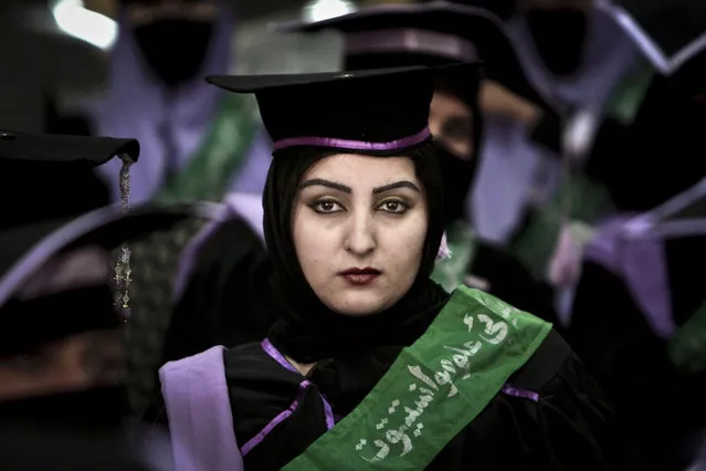 An Afghan midwife attends her graduation ceremony at the governor's house, in Jalalabad east of Kabul, Afghanistan, Wednesday, January 16, 2013. Over 52, midwives graduated after receiving 2 year of training in Jalalabad. (Photo by Rahmat Gul/AP Photo)
