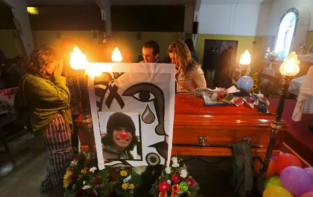 Relatives of Exequiel Borvaran, a student who was shot dead on May 14 following a protest march, attend his wake in a church in Quilpue city, Chile May 15, 2015. Authorities believe Borvaran, 18, and fellow student Diego Guzman, 25, were killed by an irate resident as they sprayed graffiti on the wall of his building. (Photo by Rodrigo Garrido/Reuters)