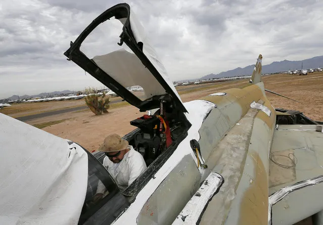A demilitarization crew member removes components from the cockpit of an F-4 Phantom slated for destruction at the 309th Aerospace Maintenance and Regeneration Group boneyard in Tucson, Ariz. on Thursday, May 21, 2015. The 309th is the United States Air Force's aircraft and missile storage and maintenance facility and provides long and short-term aircraft storage, parts reclamation and disposal. (Photo by Matt York/AP Photo)