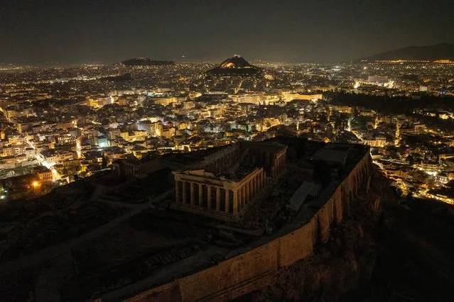 A drone view shows the ruins of the ancient Parthenon temple atop the Acropolis hill with the lights turned off during Earth Hour, in Athens, Greece, on March 23, 2024. (Photo by Stelios Misinas/Reuters)